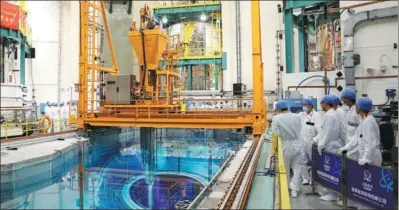  ?? HU JIE / XINHUA ?? Engineers oversee loading of nuclear fuel into Unit 5 of China’s Fuqing Nuclear Power Plant in Fuqing, Fujian province, developed by China National Nuclear Corp, on Sept 4. Unit 5 is the world’s first pilot project using Hualong One technology.