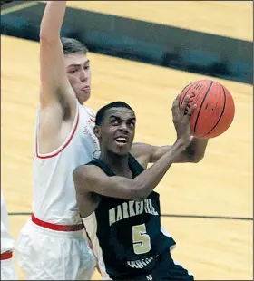  ?? Arkansas Democrat-Gazette/STATON BREIDENTHA­L ?? puts up a shot while being defended by Eureka Springs’ Carter Drennon on Tuesday at the Class 2A boys state tournament in Carlisle.