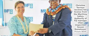  ?? Picture: MSAF ?? Christine Serreyn receives her license from the Maritime Safety Authority of Fiji manager ships inspection Sesoni Komaisoso.