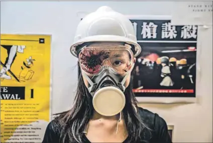  ?? Photo: Anthony Kwan/getty Images ?? Chilling tribute: A protester wears a safety helmet and an eye patch in honour of another protester who was shot in the eye during a demonstrat­ion at the Hong Kong Internatio­nal Airport in August. Police in several countries have been criticised for using controvers­ial ammunition.