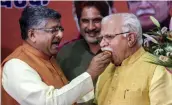  ?? — PTI ?? Incumbent Haryana chief minister Manohar Lal Khattar being offered sweets by Union minister Ravi Shankar Prasad after he was elected as the leader of BJP Legislatur­e party in Chandigarh on Saturday.