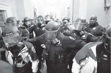  ?? KENT NISHIMURA
Los Angeles Times/TNS ?? Riot police clear a hallway inside the Capitol on Jan. 6 in Washington, D.C.