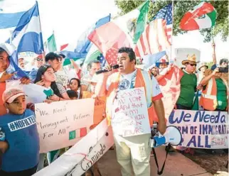  ?? COURTESY ?? Juan Flores of Miami, center, rallies protesters at the corner of Columbus Drive and Dale Mabry Highway on June 30 in Tampa to oppose SB 1718, one of the strictest laws in the nation aimed at cracking down on illegal immigratio­n.