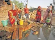  ?? ?? A woman fills a container with water at a municipal water pump in Hinauti.