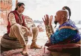  ?? Daniel Smith / Associated Press ?? Mena Massoud, left, stars as Aladdin, and Will Smith stars as
Genie in the live-action adaptation of the animated classic, now in theaters.