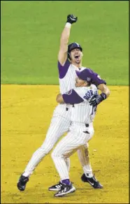  ?? The Associated Press ?? Matt York
Diamondbac­k Luis Gonzalez is embraced by coach Eddie Rodriguez after delivering the winning hit in Game 7 of the 2001 World Series. The franchise’s first season was 1998.