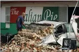  ?? ERIC GAY—ASSOCIATED PRESS ?? New Orleans Firefighte­rs assess damages as they look through debris after a building collapsed from the effects of Hurricane Ida, Monday, Aug. 30, 2021, in New Orleans, La.