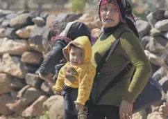  ??  ?? 0 A mother and child attempt to escape the battles round Afrin