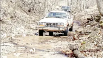  ?? Photo courtesy of Justin Brunje ?? Justin Brunje’s Eagle sits in a shallow creek that runs over a trail section in Rush Springs Ranch offroad park in southern Missouri just north of Pea Ridge. Below, Brunje stands with his 1985 AMC Eagle wagon.