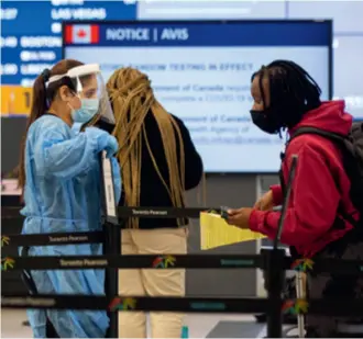  ?? ?? A traveler registers for a COVID-19 test at Toronto Pearson Airport in Canada on January 17