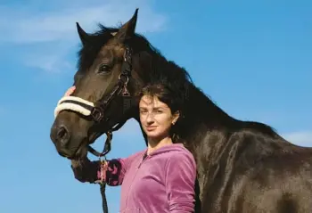  ?? VASILISA STEPANENKO/AP ?? Viktoria Skliar stands with the horse Canada on Aug. 8 near Kyiv, Ukraine. Skliar is trying to retrieve the body of her boyfriend, a Ukrainian POW who died in a prison at Olenivka, in a separatist-held area of the Donetsk region.