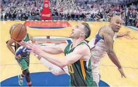  ?? [AP PHOTO] ?? Utah Jazz forward Gordon Hayward, left, shoots as Los Angeles Clippers center Marreese Speights defends during the second half in Game 7 of their first-round playoff series Sunday in Los Angeles. The Jazz won 104-91.