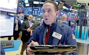  ?? — AP ?? A trader works on the floor of the New York Stock Exchange. The US equity market has become highly sensitive to inflation this month.