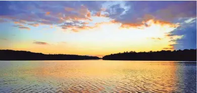  ?? CHELSEY LEWIS/MILWAUKEE JOURNAL SENTINEL ?? The sun sets over Lake Namakagon. The area is where elk were reintroduc­ed in the state in 1995.