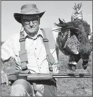  ?? Arkansas Democrat-Gazette/BRYAN HENDRICKS ?? Greg Graham admires a brace of pheasants he took with a vintage Marlin Model 90 16-gauge.