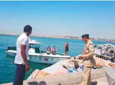  ??  ?? ■ Lt Col Ali Abdullah Al Naqbi, Director of Maritime Rescue Department at Dubai Police, inspects the rescue operation.