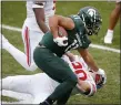 ?? AL GOLDIS — THE ASSOCIATED PRESS ?? Michigan State running back Connor Heyward (11) stiff arms Ohio State linebacker Pete Werner during the first half of Saturday’s game in East Lansing.