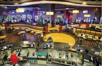  ?? NWA Democrat-Gazette/JASON IVESTER ?? Players circulate the gambling floor at Cherokee Casino in Grove, Okla. In a recently released report, tribal gambling in Oklahoma in 2015 took in $4.2 billion in total revenue, second only to California, which brought in $7.9 billion.