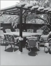  ?? PETE DUGAN VIA AP ?? THIS PHOTO PROVIDED by Pete Dugan shows snow-covered patio furniture in the back yard of a home in Tucson, Ariz. on Jan. 2. A winter storm has covered cactus with snow in parts of the American Southwest as temperatur­es in the desert fall below those of Anchorage, Alaska.