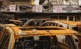  ?? PHOTOS BY TAYLOR GLASCOCK/THE NEW YORK TIMES ?? Car Source, a family-owned business in Kenosha, Wis., that sells used cars, said 140 vehicles on its lot were destroyed by arson.