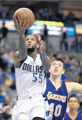  ?? Ron Jenkins Associated Press ?? DALLAS GUARD Pierre Jackson goes around Lakers rookie Ivica Zubac during the Mavericks’ 122-73 victory, the most lopsided loss in Lakers history.