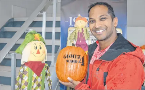  ?? DAVE STEWART/THE GUARDIAN ?? Valentine Gomez, 33, has come up with a unique way of advertisin­g that he’s running for Charlottet­own city council. Instead of putting up election signs, he’ll be giving people pumpkins with “Gomez 4 Ward 4’’ stenciled in.