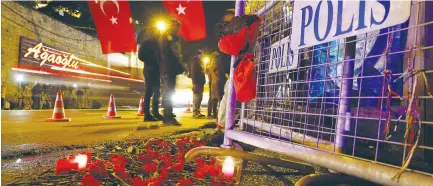  ?? (Umit Bektas/Reuters) ?? FLOWERS ARE PLACED near the entrance of the Reina nightclub, the site of the New Year’s Eve attack in Istanbul.