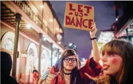  ?? Emily Kask / AFP / Getty Images ?? Strip club dancers, workers and supporters march in New Orleans on Thursday to protest recent police raids that closed several strip clubs on Bourbon Street.