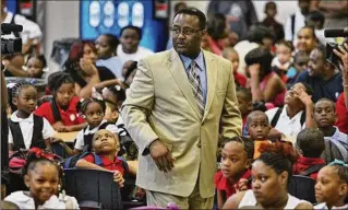  ?? JOHN SPINK/AJC FILE ?? Crawford Lewis, then superinten­dent of Dekalb County Schools, visits the Ronald E. Mcnair Discovery Learning Academy in Decatur on its first day of elementary school classes in 2008.