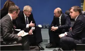  ??  ?? Boris Johnson and the Russian president, Vladimir Putin, talk to each other during their meeting on the sidelines of a conference on Libya in Berlin. Photograph: Alexei Nikolsky/AP