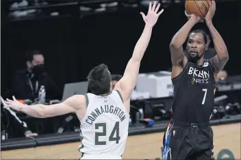  ?? KATHY WILLENS — THE ASSOCIATED PRESS ?? The Nets’ Kevin Durant shoots over the Bucks’ Pat Connaughto­n in the fourth quarter, when Durant had 20of his 49points.