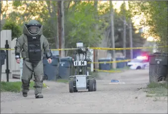  ?? NEWS PHOTO MO CRANKER ?? Members of the Medicine Hat and Lethbridge Police Services responded to an explosives call Saturday evening and used diesel fuel to subdue dynamite found in one resident's garage. It took the teams more than 12 hours to subdue the dynamite, but ended...