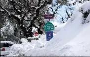  ?? ?? Snow piles up atop Highway 130at Lick Observator­y on Mount Hamilton east of San Jose on Tuesday.