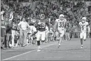  ?? OKLAHOMAN] ?? Oklahoma's sideline celebrates while running back Rhamondre Stevenson carries the ball for a 75-yard touchdown during the third quarter of Saturday's victory over South Dakota on Owen Field. [NATE BILLINGS/ THE