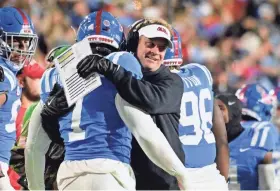  ?? MATT BUSH/USA TODAY SPORTS ?? Mississipp­i head coach Lane Kiffin reacts with defensive lineman Sam Williams (7) after a safety against Texas A&M Aggies on Nov. 13.