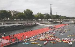  ?? AP PHOTO ?? A floating race track is set up on the Seine river in Paris on Friday. Paris is aiming to boost its bid for the 2024 Olympics by turning some of its world-famous landmarks over to sports for two days, with 100-metre races on a track floating on the...