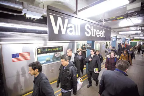  ??  ?? Commuters exit a train at a Wall Street subway station near the New York Stock Exchange in New York on March 16. — WP-Bloomberg photo