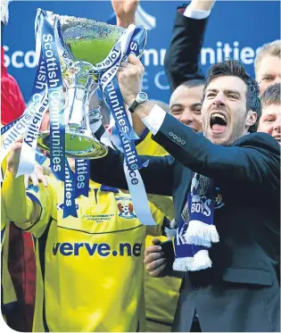  ??  ?? The injured Manuel Pascali takes to the podium to celebrate Kilmarnock’s League Cup Final win over Celtic at Hampden six years ago