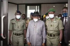  ?? (AP) ?? Former Nigerian President Goodluck Jonathan is flanked Saturday by National Committee for the Salvation of the People officials Ismael Wague (left) and Malick Diaw, as he arrives in Bamako, Mali.