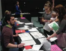  ?? RICHARD PAYERCHIN — THE MORNING JOURNAL ?? Amanda Socha, 15, a student at Avon High School, and Grace Broome, 16, a student at Wellington High School, weigh their options at one of the “life” stations during a poverty simulation exercise during the first Youth Summit of the Community Foundation...