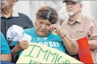  ?? AP PHOTO ?? Eldia Contreras wipes away a tear as she takes part in a vigil at San Fernando Cathedral for victims who died as a result of being transporte­d in a tractor-trailer Sunday.