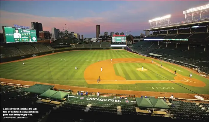  ?? JONATHAN DANIEL/GETTY IMAGES ?? A general view at sunset as the Cubs take on the White Sox in an exhibition game at an empty Wrigley Field.
