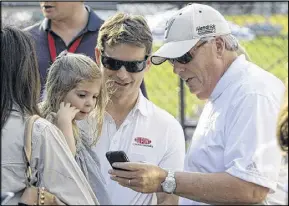 ?? CHUCK BURTON ?? Jeff Gordon, holding his daughter, Ella Sofia, spends a memorable moment or two with team owner Rick Hendrick before the Sprint AllStar race in Concord, N.C., in May of 2010.