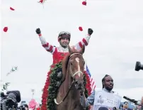  ?? PHOTO: REUTERS ?? Home and rosed . . . Jockey Sonny Leon throws roses in celebratio­n after the win of outsider Rich Strike at the 148th Kentucky Derby at Churchill Downs in Louisville yesterday.