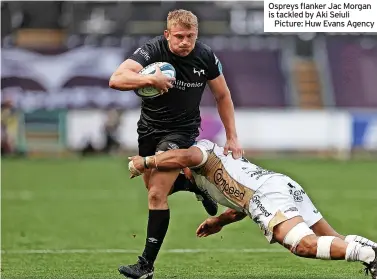  ?? ?? Ospreys flanker Jac Morgan is tackled by Aki Seiuli
Picture: Huw Evans Agency