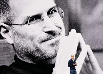  ?? Bloomberg ?? Tim Cook, chief executive officer of Apple Inc, speaks during the launch of the latest iPhones at the Steve Jobs Theatre in California. Below, a guest at the event checks out the new iPhone