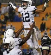  ?? GENE J. PUSKAR — THE ASSOCIATED PRESS ?? Penn State wide receiver Mac Hippenhamm­er (12) celebrates with offensive lineman C.J. Thorpe (69) after scoring a touchdown during the second half of an NCAA college football game against Pittsburgh in Pittsburgh, Saturday. Penn State won 51-6.