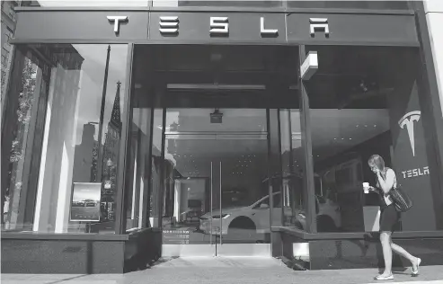  ?? SAUL LOEB / AFP / GETTY IMAGES FILES ?? A Tesla showroom in Washington. Tesla CEO Elon Musk disclosed on Monday he was in talks with Saudi Arabia’s sovereign wealth fund and other investors to take the electric-car maker private. The revelation comes after Musk’s Aug. 7 claim that financing for such a deal had been “secured.”