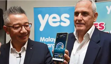  ??  ?? Wing (left) and Tabassi say that Malaysians can enjoy 4G+ connectivi­ty which offers speeds of up to 110Mbps if they have a compatible smartphone. — P. NATHAN/The Star