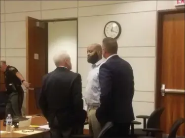  ?? KEITH REYNOLDS — THE MORNING JOURNAL ?? Abline Cannon, 38, of Cleveland, center, talks with his attorneys after giving testimony Aug. 23 in his murder trial.